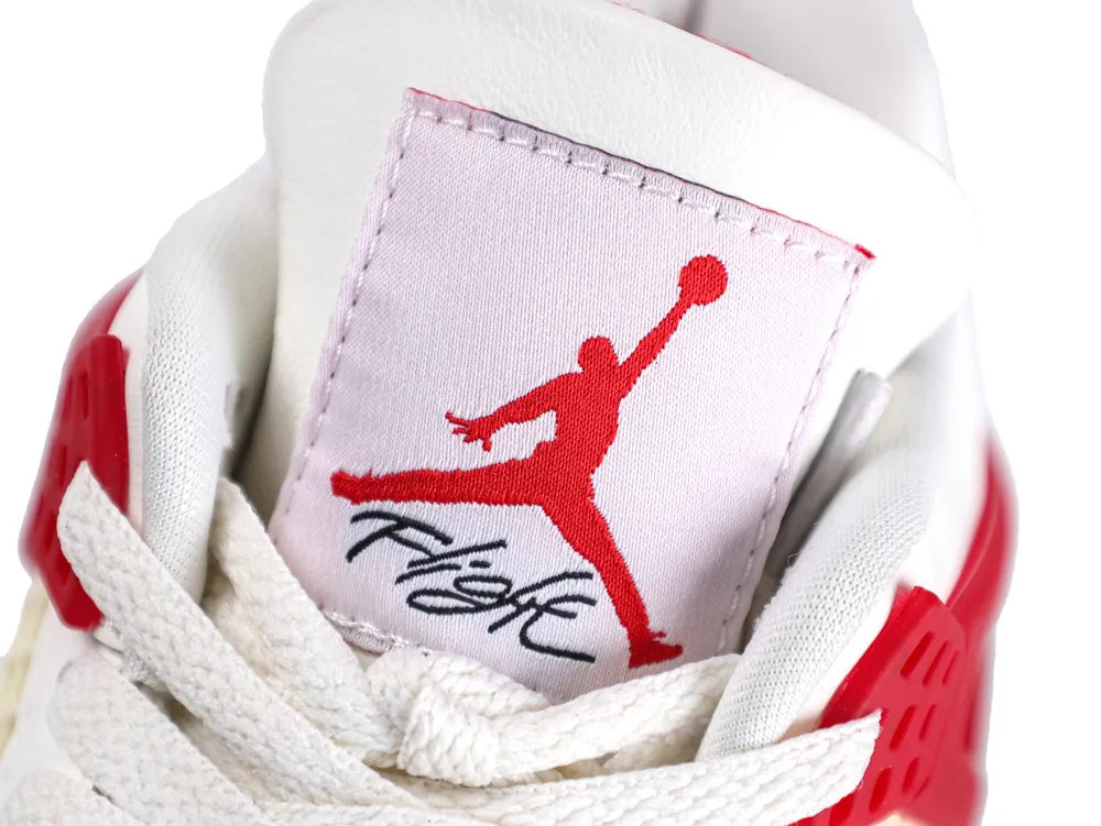 White and red sneaker tongue with a fabric label and stitched logo.