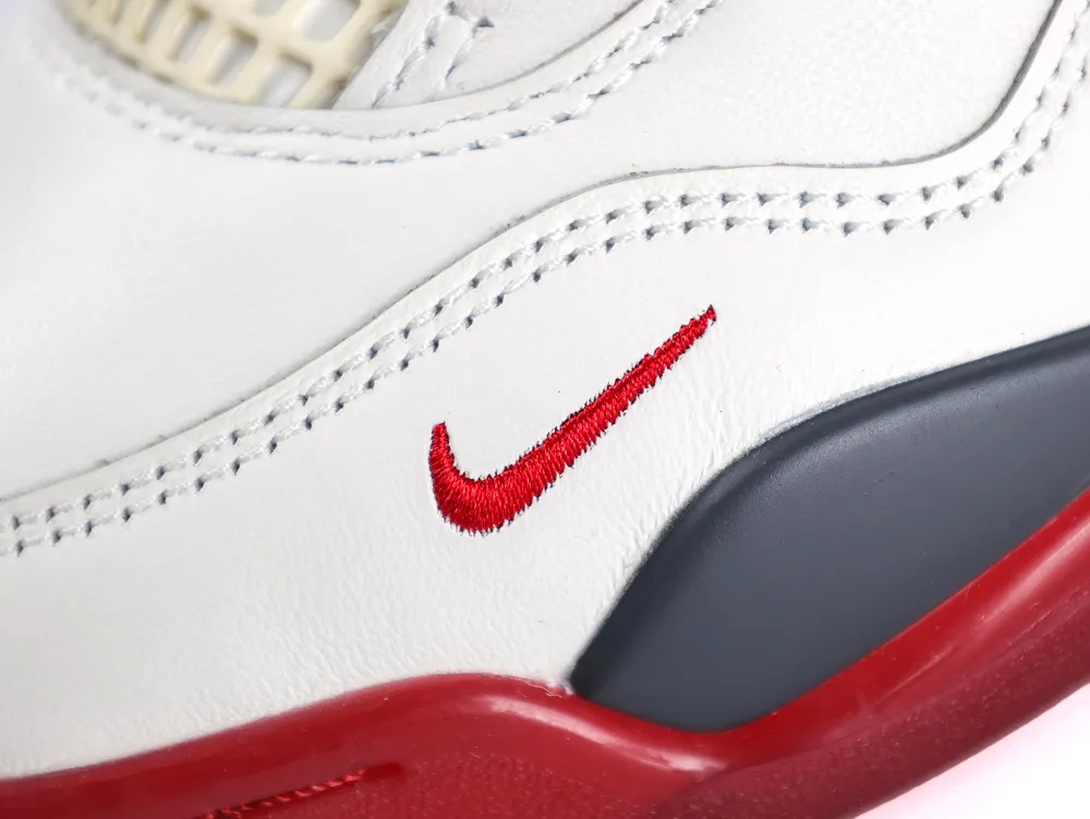White leather shoe with red and black accents, featuring detailed stitching.