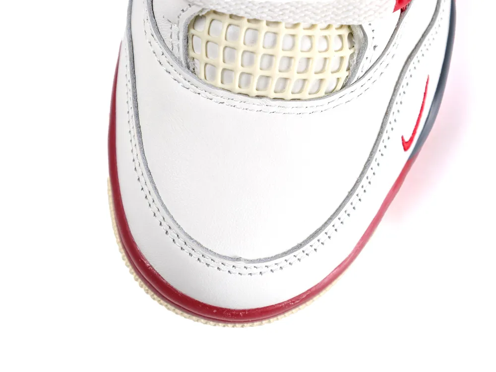 White leather sneaker with red accents and mesh toe box for ventilation.