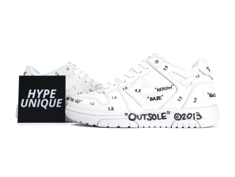 White leather sneakers with black text and numbers on various parts.