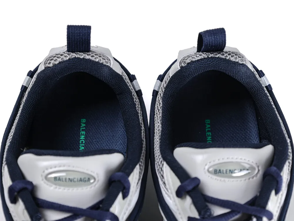 A pair of Balenciaga Radar Sneakers viewed from above, showing the navy blue mesh lining and green logo on the insoles.