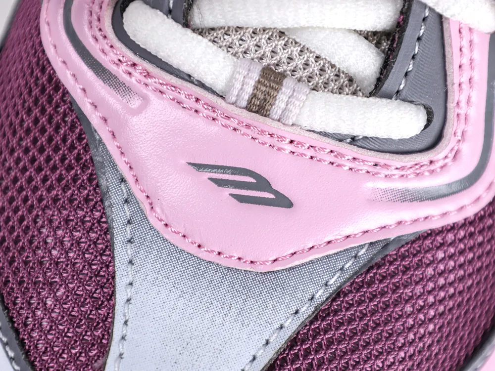 Detail shot of the Balenciaga "B" logo on the pink leather panel of the Radar sneaker.