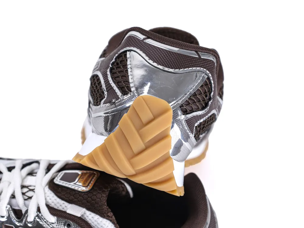 Brown mesh sneaker with silver accents and a gum-colored rubber sole.