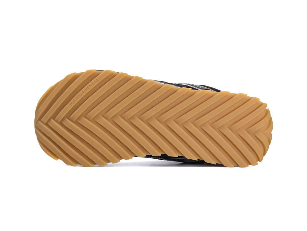 Tan rubber sole with herringbone pattern, part of a shoe's bottom.