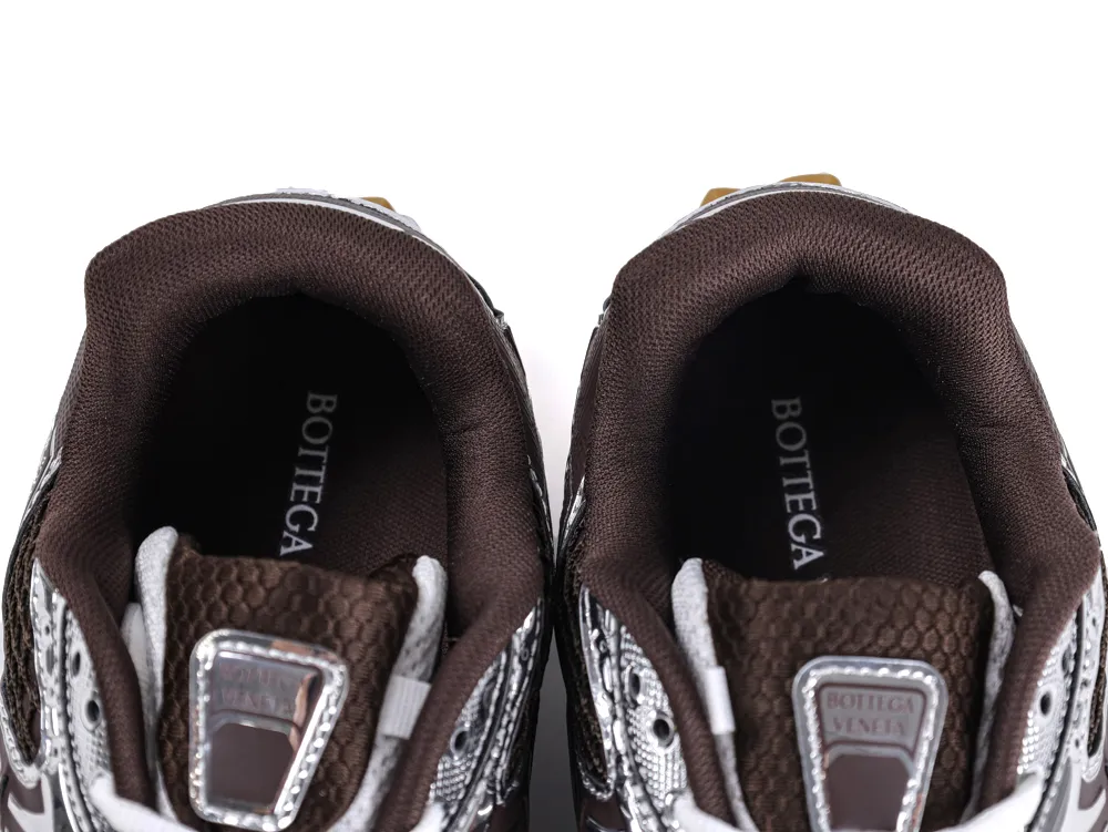 Detail shot of the tongue on Bottega Veneta Orbit Sneaker with embossed silver logo plaque