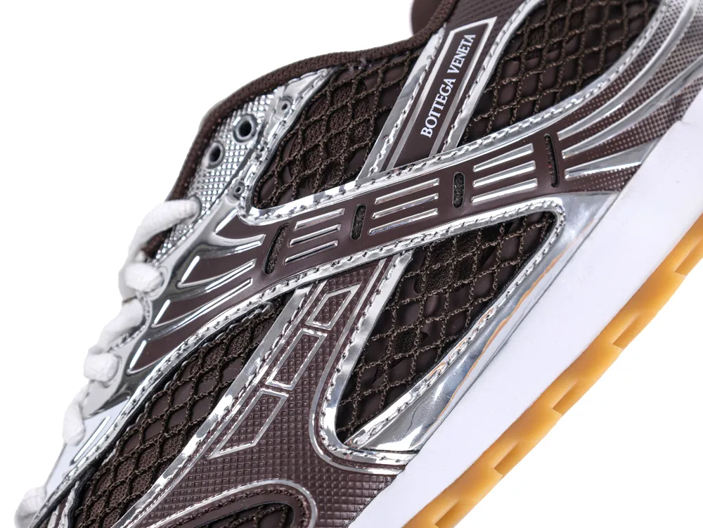 Brown and silver sneaker with a mesh design and rubber sole.