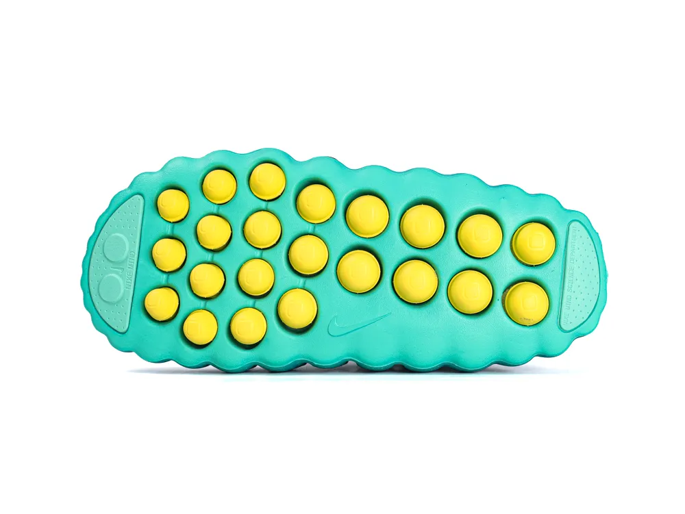 Teal rubber outsole of Nike Mind 001 sneaker with traction pattern