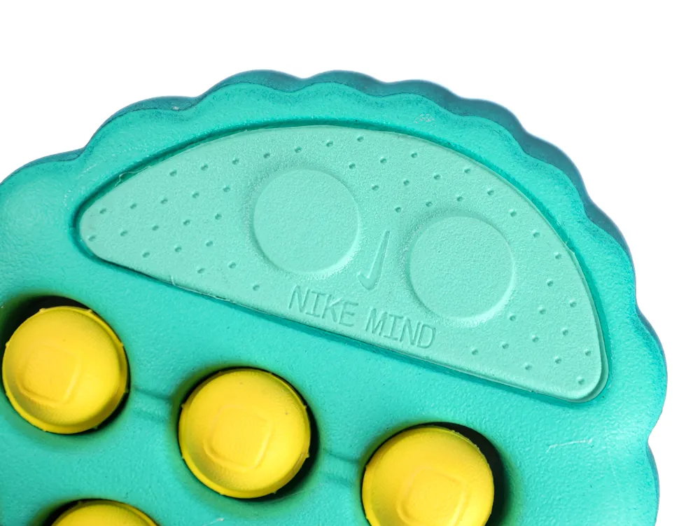 Close-up of Nike logo and Mind 001 branding on Geode Teal sneaker