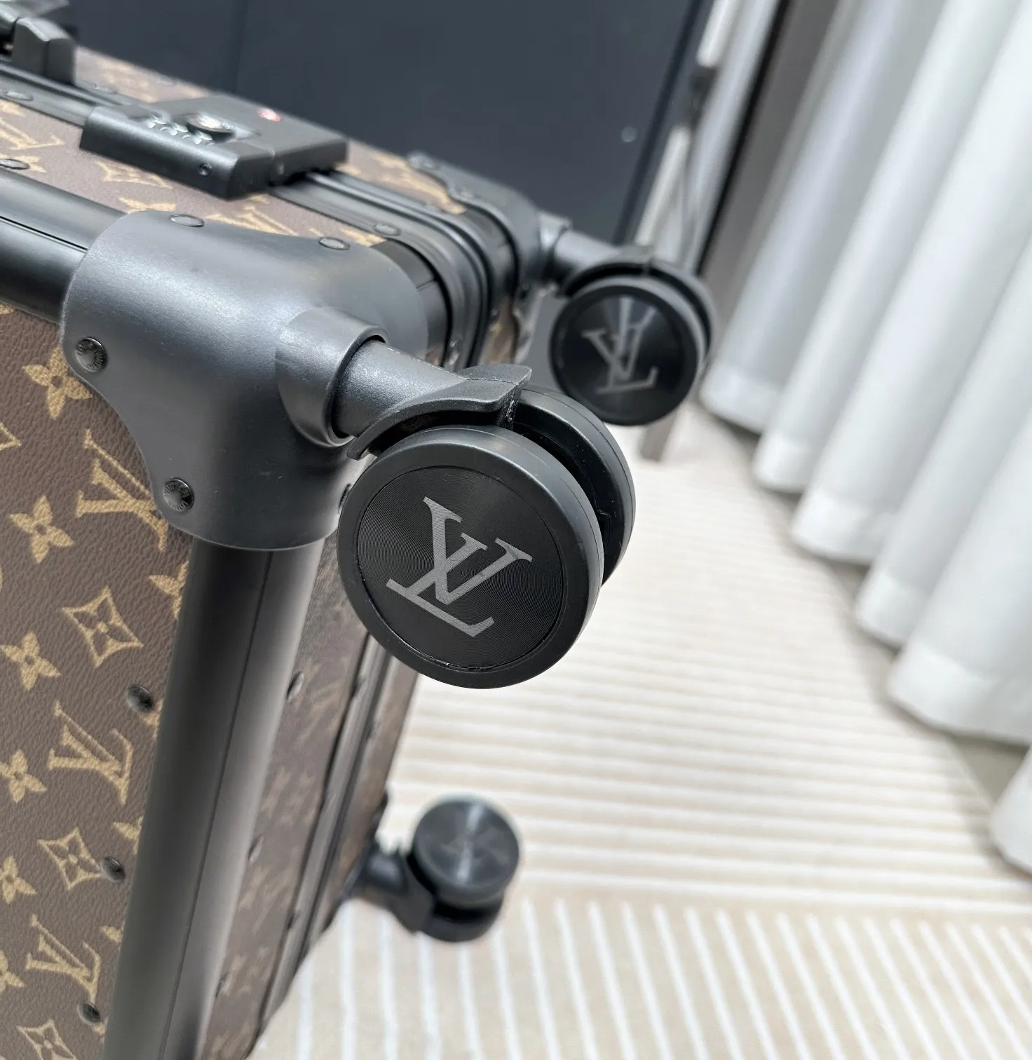 Classic monogram luggage spinner wheel detail