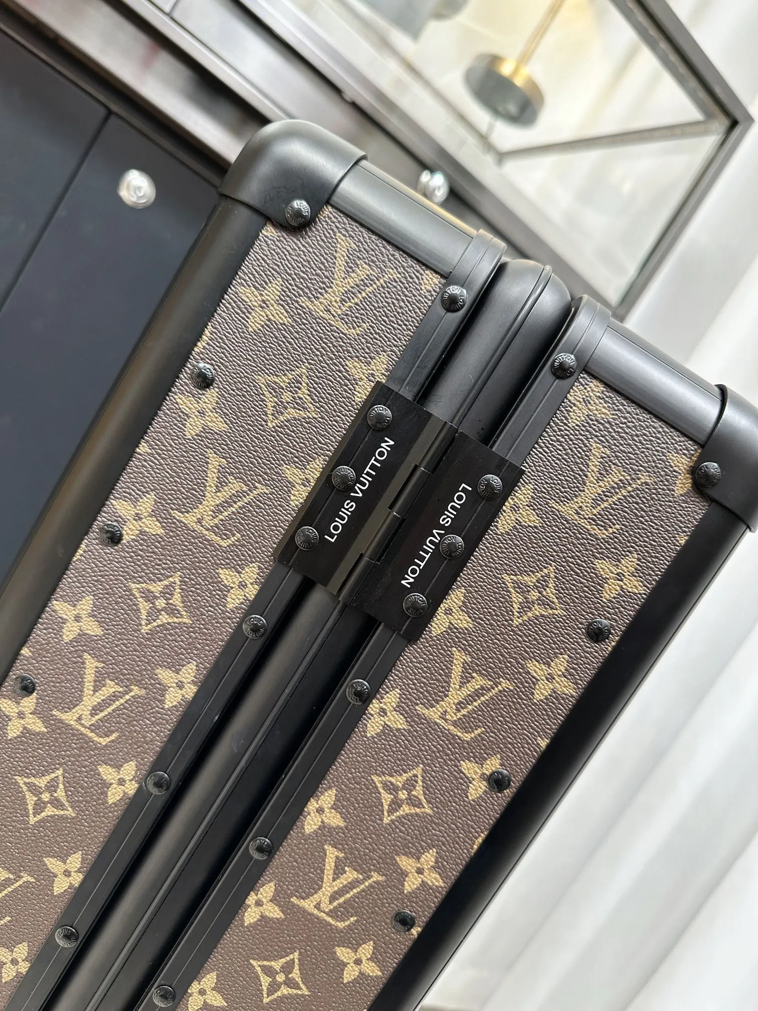 Classic monogram luggage frame and hinge detail