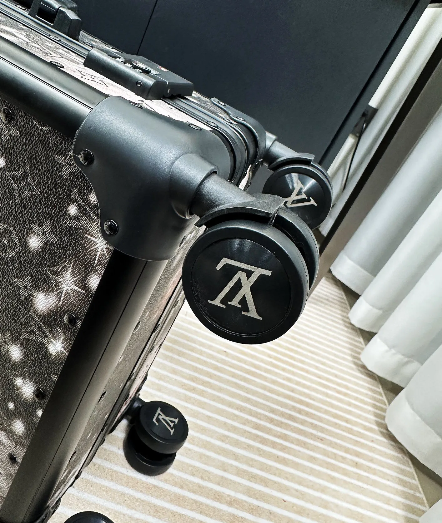 Galaxy monogram luggage spinner wheel detail