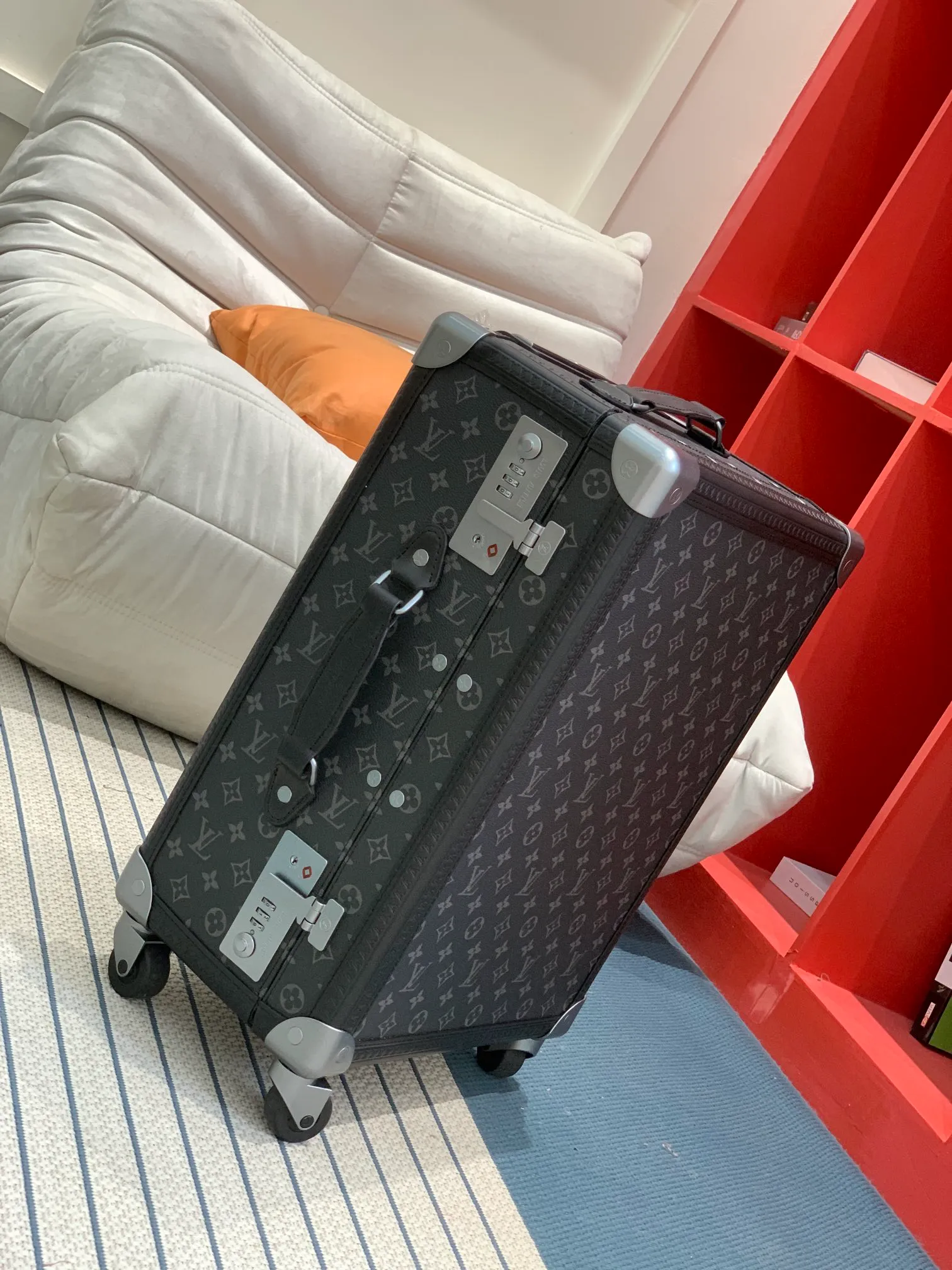 Black monogram rolling trunk side view