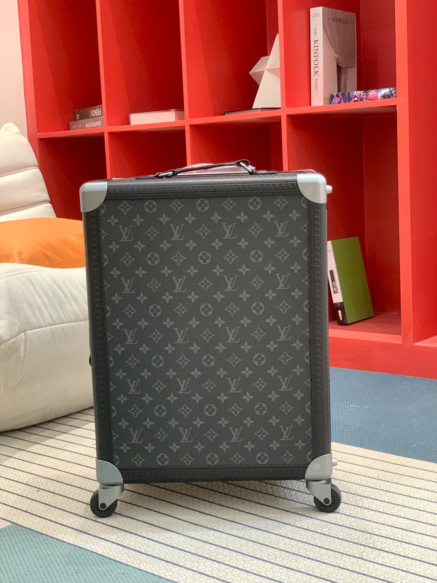 Black monogram rolling trunk front view