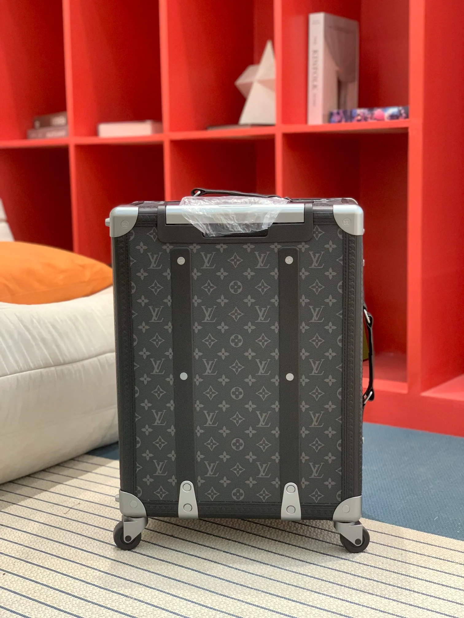 Black monogram rolling trunk rear view